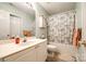 Bright bathroom featuring a shower-tub combo with a floral curtain and a white vanity at 413 Lexie Ln # 92, Rock Hill, SC 29732