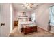 Charming pink bedroom with patterned quilt, chest at the foot of the bed, and natural light at 413 Lexie Ln # 92, Rock Hill, SC 29732