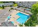 Overhead shot of a bright community pool with lounge chairs and umbrellas, surrounded by parking and townhomes at 413 Lexie Ln # 92, Rock Hill, SC 29732