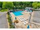 Aerial view of community pool with sun loungers, picnic tables, and a pool house at 413 Lexie Ln # 92, Rock Hill, SC 29732