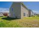 A sunny backyard with a grassy lawn and views of neighboring homes at 4200 Long Arrow Dr, Concord, NC 28025