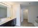 Bathroom featuring double sinks and a view into the walk-in closet at 4200 Long Arrow Dr, Concord, NC 28025