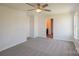 A cozy bedroom with a ceiling fan and a view into the bathroom at 4200 Long Arrow Dr, Concord, NC 28025