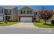 Traditional two-story home with a brick-accented front, two-car garage, and a well-maintained front lawn at 4200 Long Arrow Dr, Concord, NC 28025
