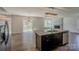 Open floorplan showcasing granite island, stainless appliances, and hardwood flooring at 4200 Long Arrow Dr, Concord, NC 28025