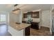 Kitchen with stainless steel appliances, granite countertops, a kitchen island, and dark wood cabinets at 4200 Long Arrow Dr, Concord, NC 28025