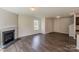 Spacious living room with fireplace, hardwood floors, and a bright window with natural light at 4200 Long Arrow Dr, Concord, NC 28025