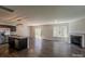 Open-concept living room features a fireplace, hardwood floors, and stainless steel appliances in the kitchen at 4200 Long Arrow Dr, Concord, NC 28025