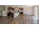 Open living space features hardwood floors, stainless appliances, an island, and sliding glass doors at 4200 Long Arrow Dr, Concord, NC 28025