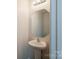 Cozy powder room features a pedestal sink with a modern mirror and lighting at 4200 Long Arrow Dr, Concord, NC 28025