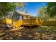 Backyard showcasing a wooden deck, new fence, and lush green landscaping at 4429 Major St, Charlotte, NC 28208