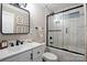 Modern bathroom featuring sleek black hardware, white marble-style tile, and glass shower door at 4429 Major St, Charlotte, NC 28208