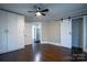 Spacious bedroom with hardwood floors, ceiling fan, and sliding barn door closet at 4429 Major St, Charlotte, NC 28208