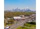 High rise city skyline view from a distance with surrounding trees and highway at 4429 Major St, Charlotte, NC 28208
