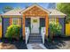 Inviting entryway with a wooden porch, stone walkway, and professionally landscaped yard at 4429 Major St, Charlotte, NC 28208