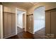 Hallway with dark hardwood floors, paneled walls, and an arched doorway at 4429 Major St, Charlotte, NC 28208