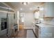 Modern kitchen with stainless steel refrigerator, white cabinets, and quartz countertops at 4429 Major St, Charlotte, NC 28208