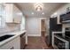 Modern kitchen with stainless steel refrigerator, white cabinets, and quartz countertops at 4429 Major St, Charlotte, NC 28208