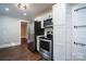 Kitchen showcasing stainless steel appliances, white cabinetry and a black stove at 4429 Major St, Charlotte, NC 28208
