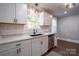 Bright kitchen featuring white cabinets, stainless steel appliances, and a subway tile backsplash at 4429 Major St, Charlotte, NC 28208