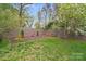 Backyard view with privacy fence and garden, and a swinging chair for relaxing at 4541 Bradbury Dr, Charlotte, NC 28209