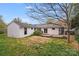 View of backyard with deck and light-colored exterior of home with turquoise door at 4541 Bradbury Dr, Charlotte, NC 28209