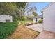 Backyard featuring a patio, shed, and lush landscaping, with a white-brick home at 4541 Bradbury Dr, Charlotte, NC 28209