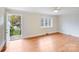 Well-lit bedroom with hardwood floors, large windows, and direct access to outdoor space at 4541 Bradbury Dr, Charlotte, NC 28209