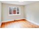 Bright bedroom features hardwood floors and a large window offering natural light at 4541 Bradbury Dr, Charlotte, NC 28209