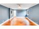 Bright bedroom with hardwood floors, a ceiling fan, and two windows at 4541 Bradbury Dr, Charlotte, NC 28209