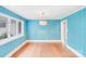 Bright dining room featuring hardwood floors, crisp, white trim, and vibrant blue accent walls at 4541 Bradbury Dr, Charlotte, NC 28209