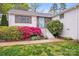 Charming home featuring a light blue front door, brick facade, and beautiful landscaping at 4541 Bradbury Dr, Charlotte, NC 28209