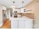 Well-lit kitchen with stainless steel appliances, stylish pendant lights, and a breakfast bar at 4541 Bradbury Dr, Charlotte, NC 28209