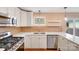 Bright kitchen featuring stainless steel appliances, tiled backsplash, and ample countertop space at 4541 Bradbury Dr, Charlotte, NC 28209
