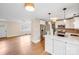 Open layout connects the kitchen with bar seating to a living room with hardwood floors at 4541 Bradbury Dr, Charlotte, NC 28209