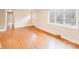 Open living space with hardwood floors, large windows, and neutral walls at 4541 Bradbury Dr, Charlotte, NC 28209