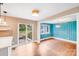 Open floorplan with kitchen, bar, slider door, and separate dining room with vibrant blue walls at 4541 Bradbury Dr, Charlotte, NC 28209