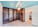 Large walk-in closet with custom shelving and drawer units next to the bathroom at 4541 Bradbury Dr, Charlotte, NC 28209