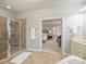 Ensuite bathroom features a glass door shower and tiled flooring, and an open view to the main bedroom at 516 White Tail Ter, Waxhaw, NC 28173