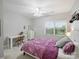 Cozy bedroom with a patterned bedspread, desk, and a large window overlooking the yard at 516 White Tail Ter, Waxhaw, NC 28173