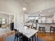 Dining area with a marble table, hardwood floors, and an open view into the kitchen at 516 White Tail Ter, Waxhaw, NC 28173