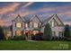 Beautiful two-story home with a well-manicured lawn and lush landscaping at 516 White Tail Ter, Waxhaw, NC 28173
