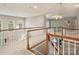 Bright hallway with white railings and plenty of natural light from the large windows at 516 White Tail Ter, Waxhaw, NC 28173