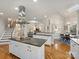 Open-concept kitchen with a center island, stainless steel appliances, and hardwood floors at 516 White Tail Ter, Waxhaw, NC 28173