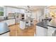 Modern kitchen with white cabinets, stainless steel appliances, and an island with seating at 516 White Tail Ter, Waxhaw, NC 28173