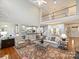 Open-concept living room with hardwood floors, a large rug, and a view of the upper level at 516 White Tail Ter, Waxhaw, NC 28173