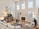 Bright living room featuring high ceilings, large windows, a fireplace, and comfortable seating at 516 White Tail Ter, Waxhaw, NC 28173
