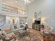 Spacious living room with hardwood floors, comfortable seating, and a view of the upper level at 516 White Tail Ter, Waxhaw, NC 28173