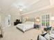 Spacious carpeted main bedroom with tray ceiling boasts a seating area, dresser and a view to the ensuite bathroom at 516 White Tail Ter, Waxhaw, NC 28173