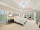 Spacious main bedroom featuring a tray ceiling, large windows with shutters, and luxurious carpeting at 516 White Tail Ter, Waxhaw, NC 28173